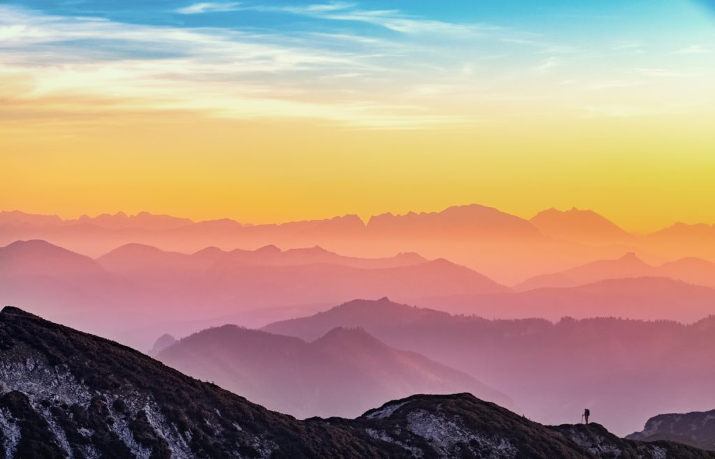 Mobile App Design. Image from unsplash of coloured sky over mountain range